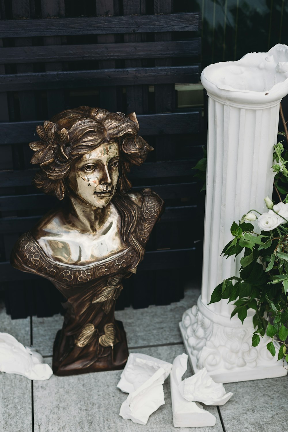 a statue of a woman with a flower pot next to it