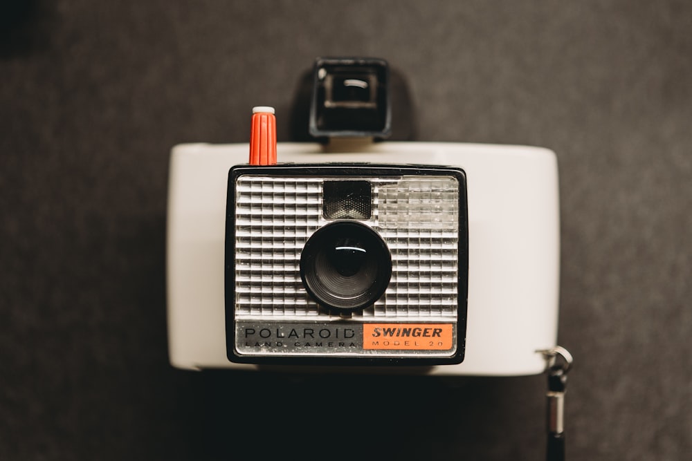 a polaroid swinger camera sitting on top of a table