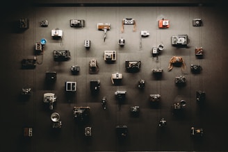 A stylish camera setup with vintage and modern cameras arranged artistically against a dark background.