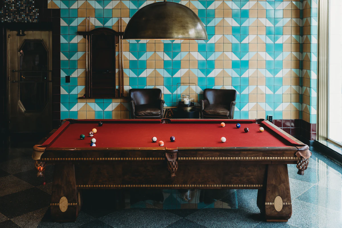 Pool table set up for a competitive match, with cue ball ready