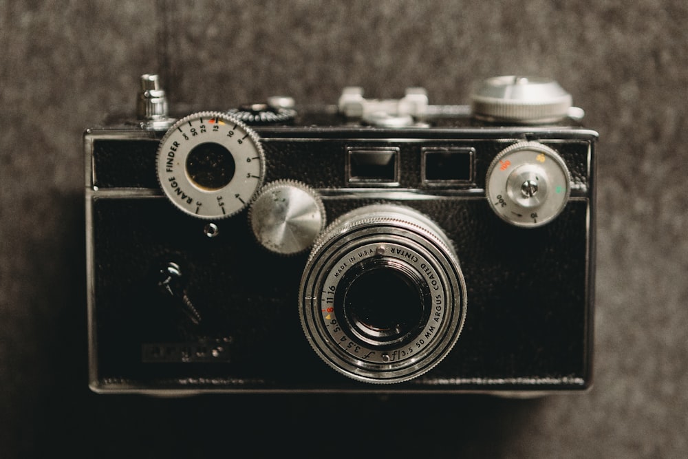 an old fashioned camera is sitting on a table