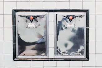 The odpirač can opener mounted on a kitchen wall in a bright restaurant setting.