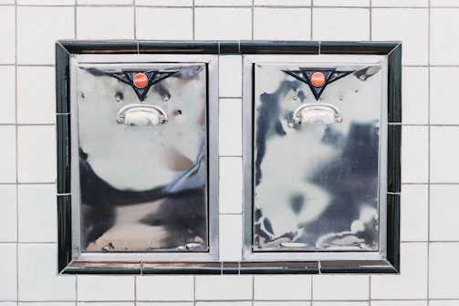 The odpirač can opener mounted on a kitchen wall in a bright restaurant setting.