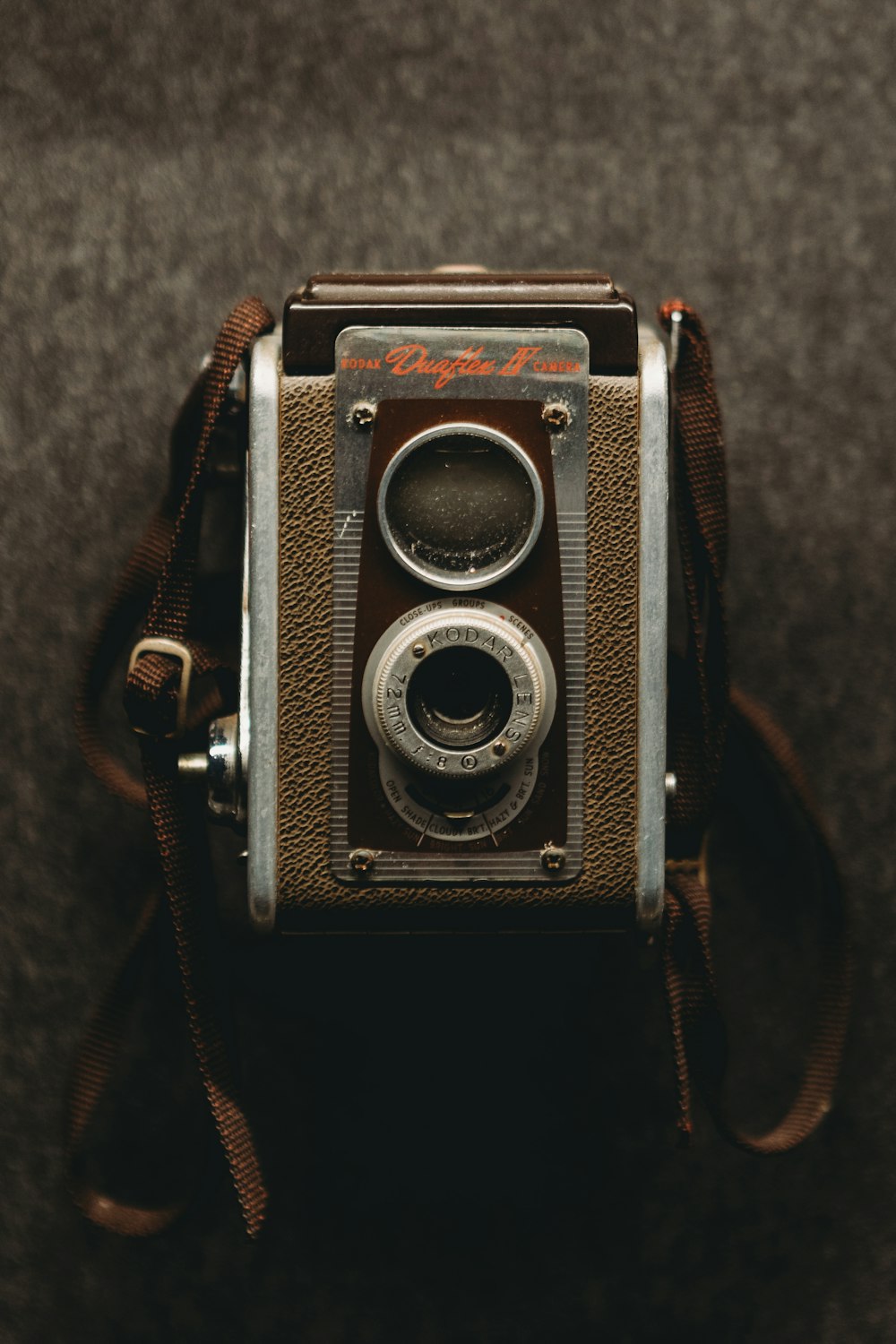 an old fashioned camera sitting on top of a table