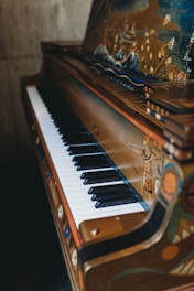 An elegant music box shaped like a grand piano with delicate painted details.