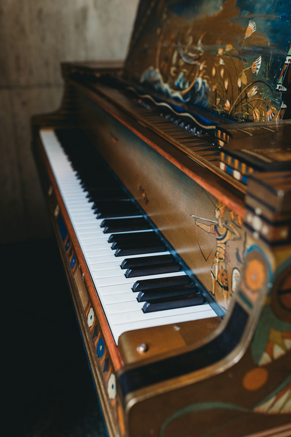 a close up of a piano with a painting on it