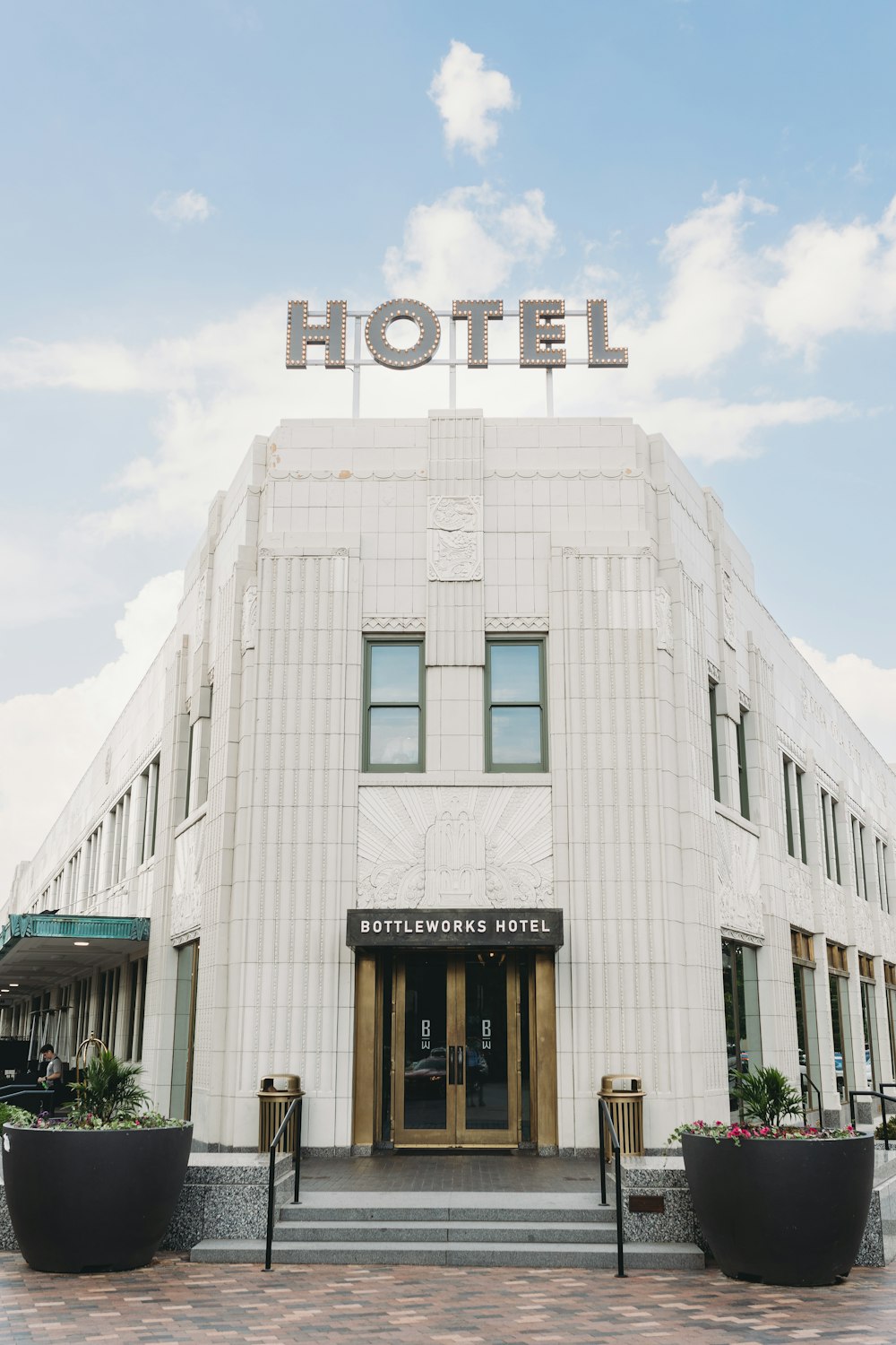 um grande edifício branco com uma placa que diz hotel