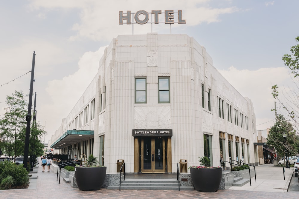 a white building with a sign that reads hotel