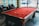 A happy customer playing pool at home with egabillards products.