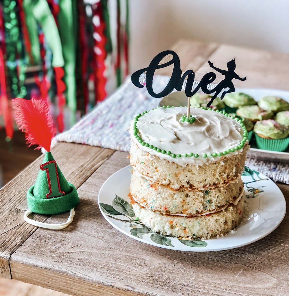 a cake on a plate with a one's candle on top of it