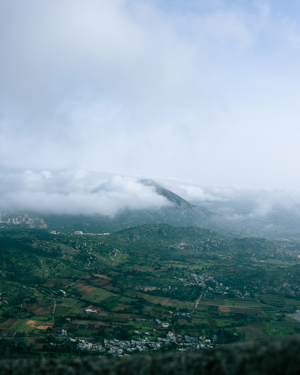 a view of a mountain with clouds in the sky