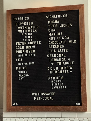 A stylish coffee shop with a digital menu board.
