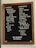 A stylish coffee shop menu board with a wooden frame features a variety of drink options. The left column lists 'Classics' including espresso with choices of water or milk, filter coffee, cold brew, pour-over, and tea. Various milk alternatives are also offered, such as whole, almond, and oat. The right column presents 'Signatures' like mocha, tres leches, chai, matcha, and hot cocoa, along with unique options such as Bermuda, Triangle, Cold Brew Horchata, and assorted syrups. The board also displays the WiFi password: Methodical.