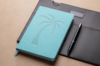 Elegant close-up shot of glossy business documents and a pen, set against a turquoise background.