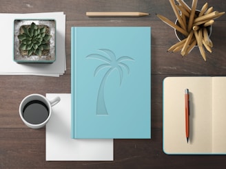 A sleek notebook and planner open on a desk, surrounded by pens and a branded water bottle.