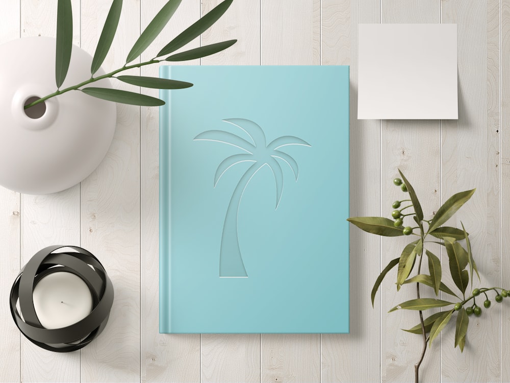 a blue book with a palm tree cut out of it