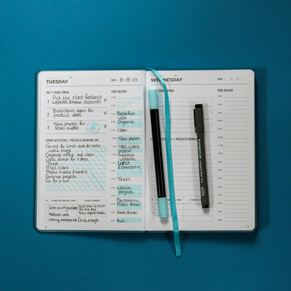 a notepad with a pen on top of it