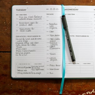 a planner with a pen on top of it