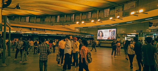 A busy metro station in Delhi filled with commuters during rush hour.