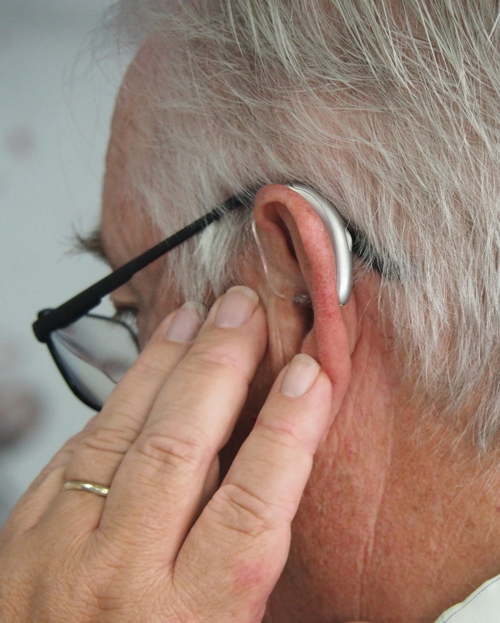 a man wearing glasses and a pair of ear phones