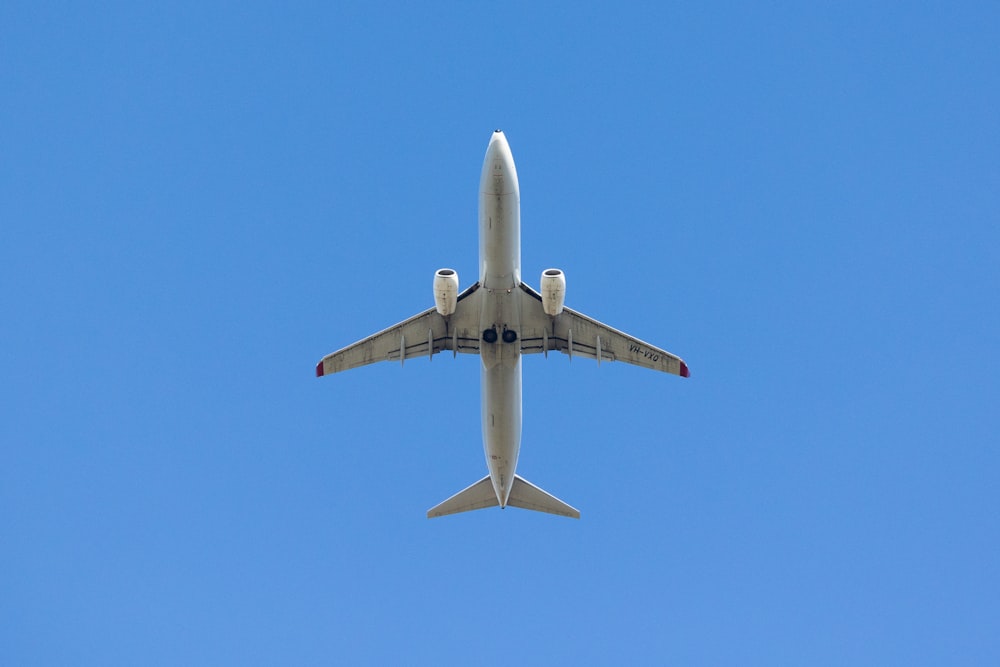 a large jetliner flying through a blue sky