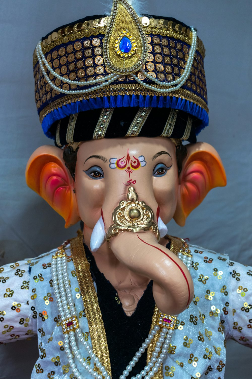 a statue of an elephant wearing a headdress