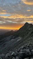 A wide shot of an outdoor scene filmed at golden hour with dramatic shadows.