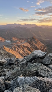 A rugged mountain landscape at sunset with vivid colors.
