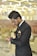 a man in a suit looking at his cell phone