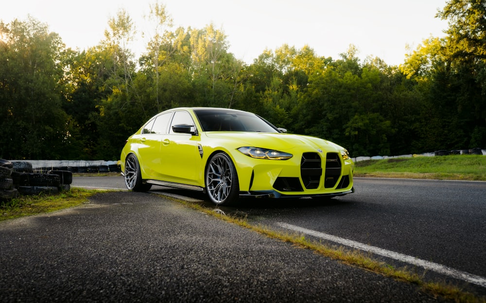 a yellow car parked on the side of a road