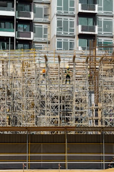 a building under construction with scaffolding and workers