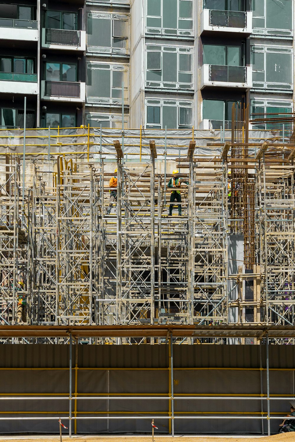 a building under construction with scaffolding and workers