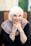 a woman with white hair sitting on a chair