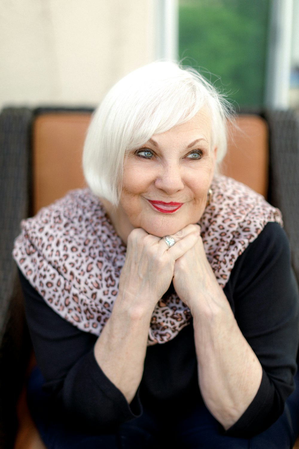 a woman with white hair sitting on a chair