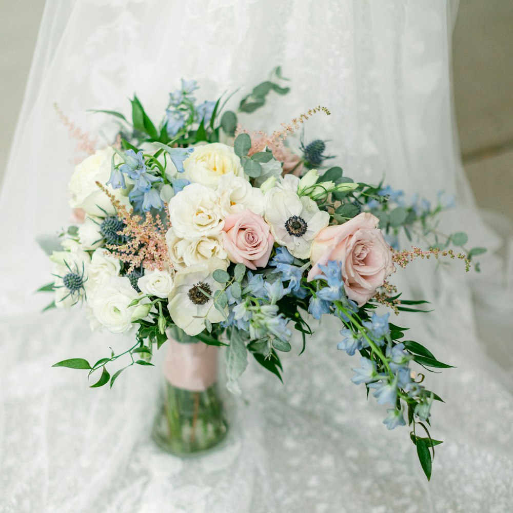 a bouquet of flowers in a vase on a table