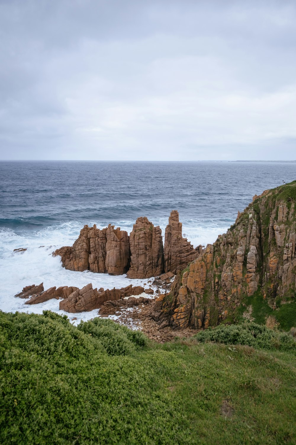 a view of the ocean from the top of a hill