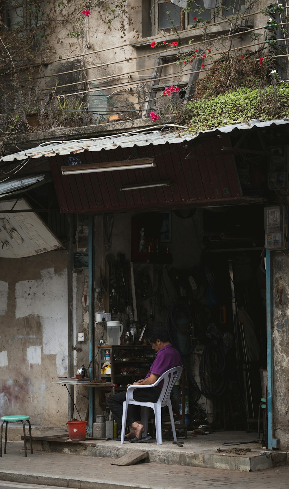 a man sitting in a chair in front of a store