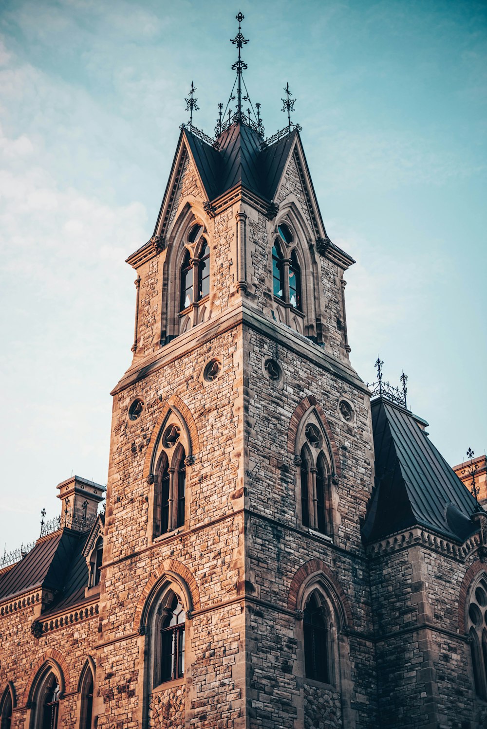 a large stone building with a clock on it's side