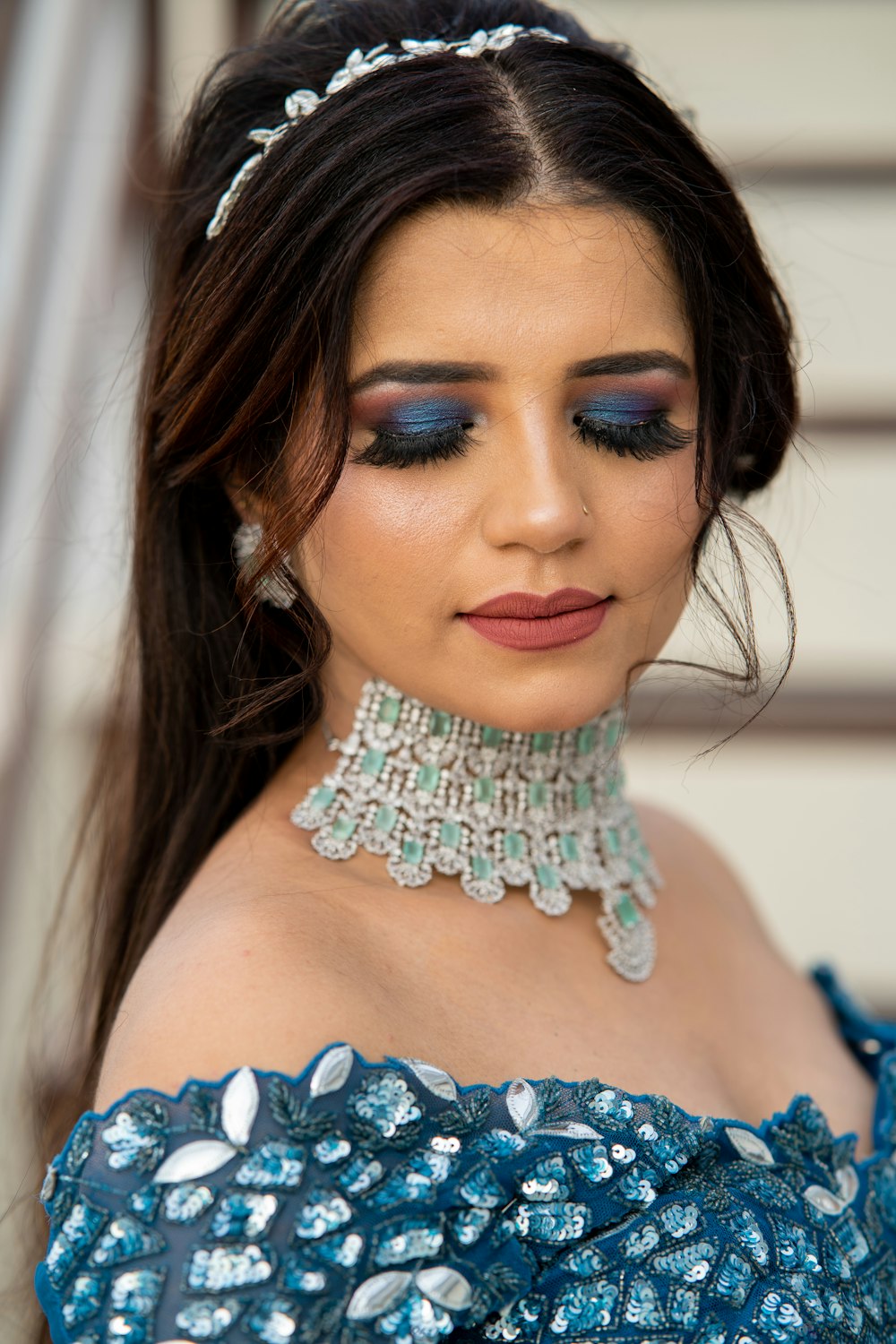 a woman wearing a blue dress and a tiara