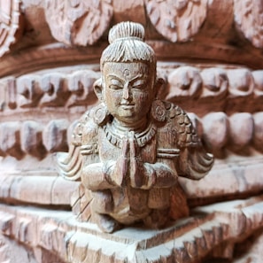 A beautifully carved wooden figurine, showcasing the artisan's detailed craftsmanship.