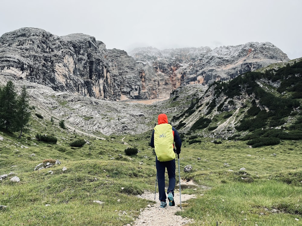 a person walking up a trail in the mountains