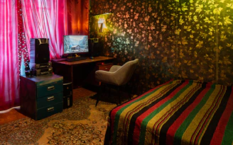 A cozy room wall adorned with vibrant wall stickers and elegant wallpaper designs.