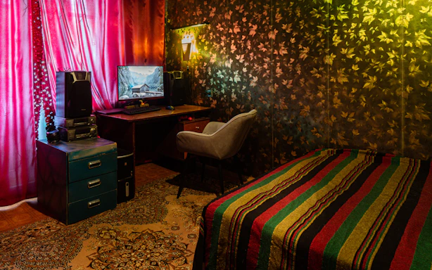 A cozy room wall adorned with vibrant wall stickers and elegant wallpaper designs.