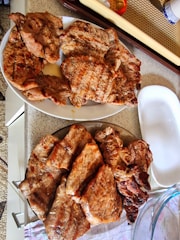 Set of custom barbecue tools arranged neatly on a matte black countertop