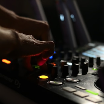 a dj mixing a track in a dark room