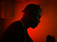 A silhouette of a person listening intently with eyes closed, immersed in the music’s flow.