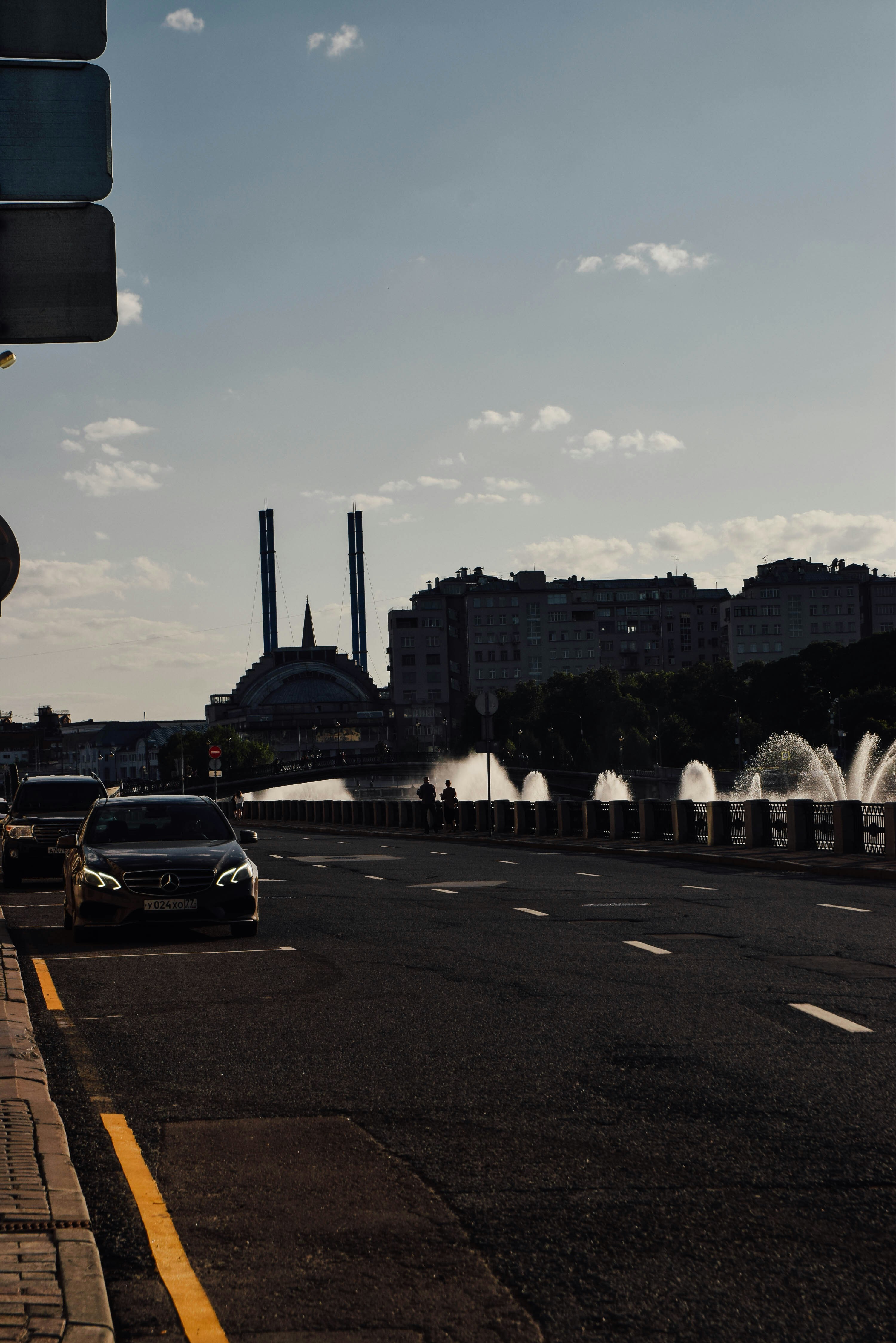 A car driving down a street next to a traffic light photo – Free Dark ...