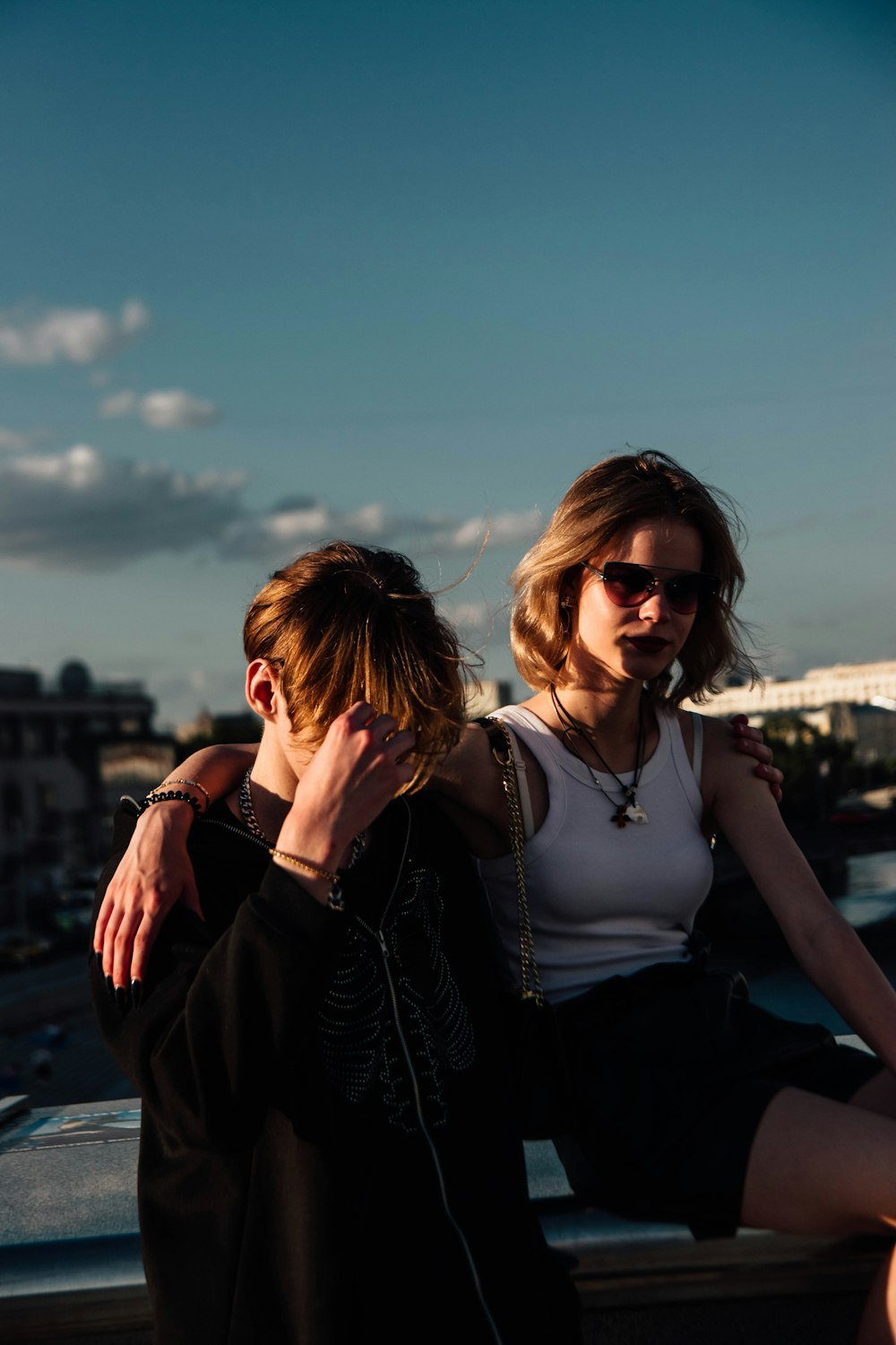 a couple of people that are sitting on a ledge