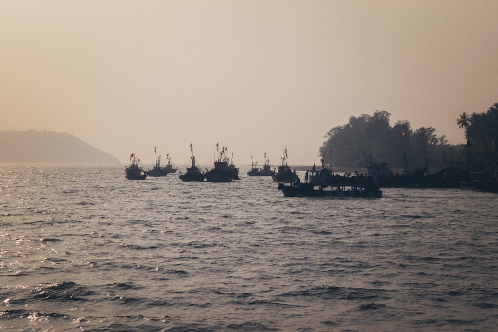 a group of boats floating on top of a large body of water