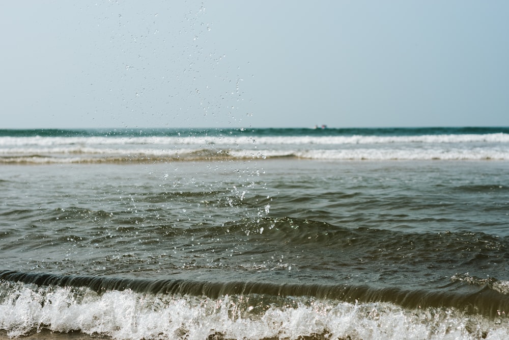 a person riding a surfboard on top of a wave